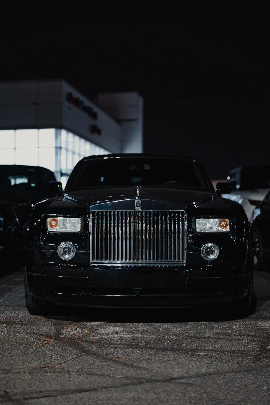 Black Rolls-Royce Phantom photographed head-on at night