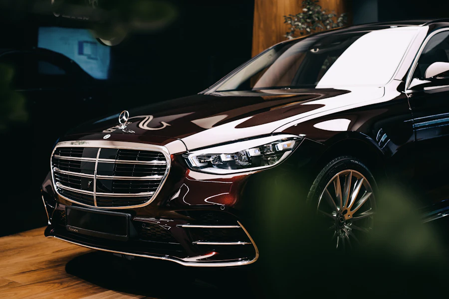 Black Mercedes-Benz S-Class saloon lit in a darkened room